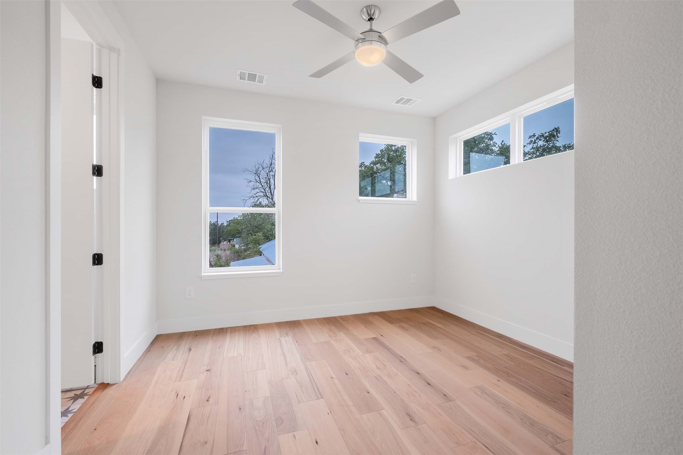 4513 South 3rd Street, Unit 2 Austin, TX 78745 - Photo 14 of 29 wooden floor in an empty room with a window
