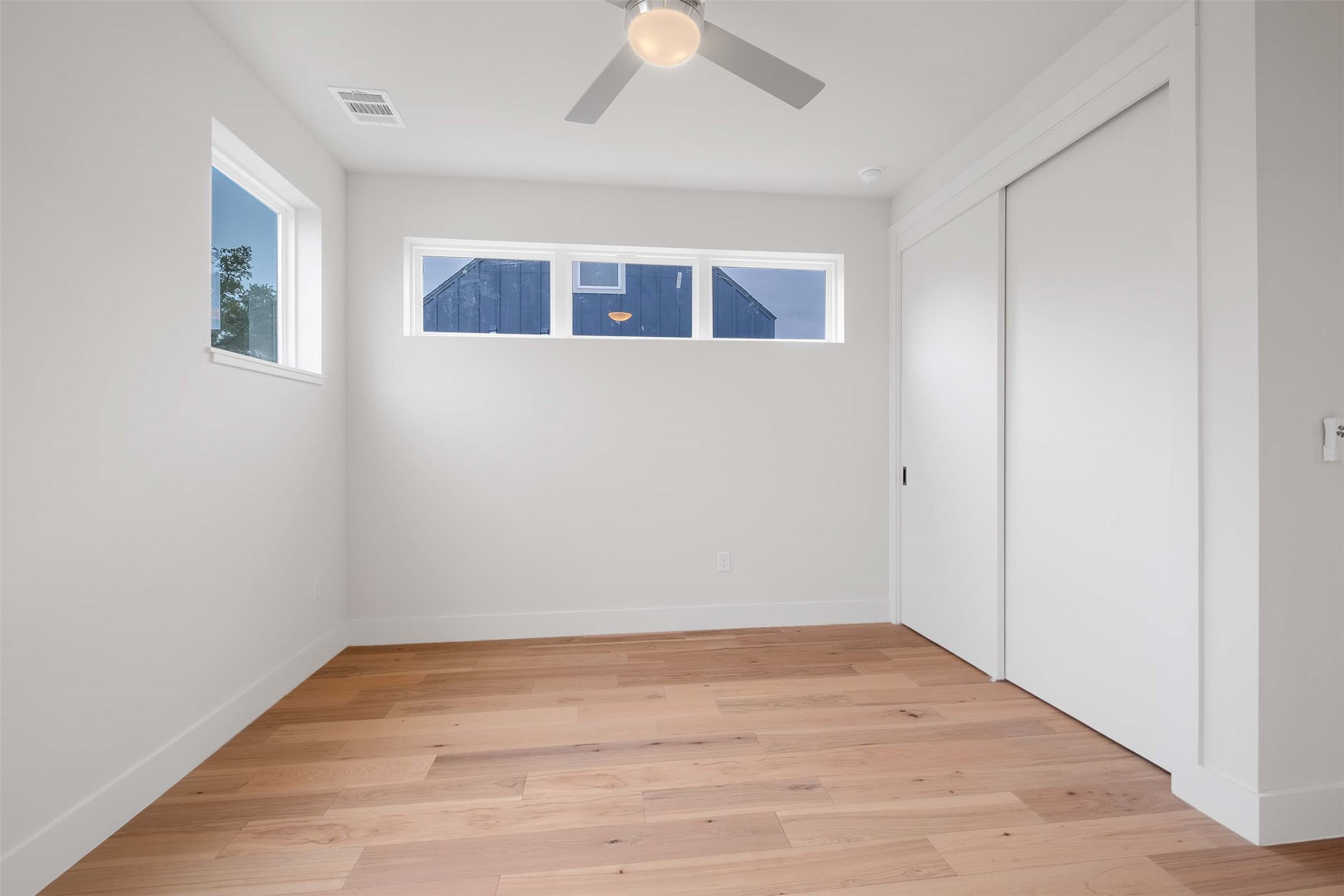 4513 South 3rd Street, Unit 2 Austin, TX 78745 - Photo 16 of 29 wooden floor in an empty room with a window