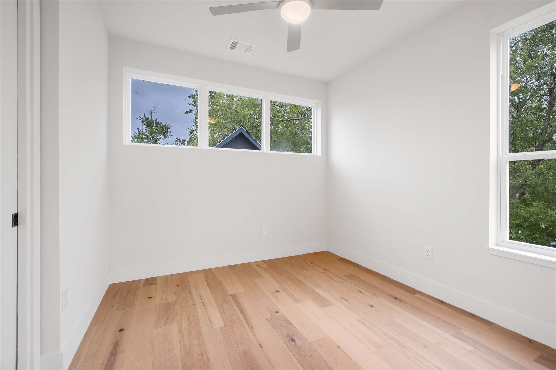 4513 South 3rd Street, Unit 2 Austin, TX 78745 - Photo 23 of 29 wooden floor in an empty room with a window