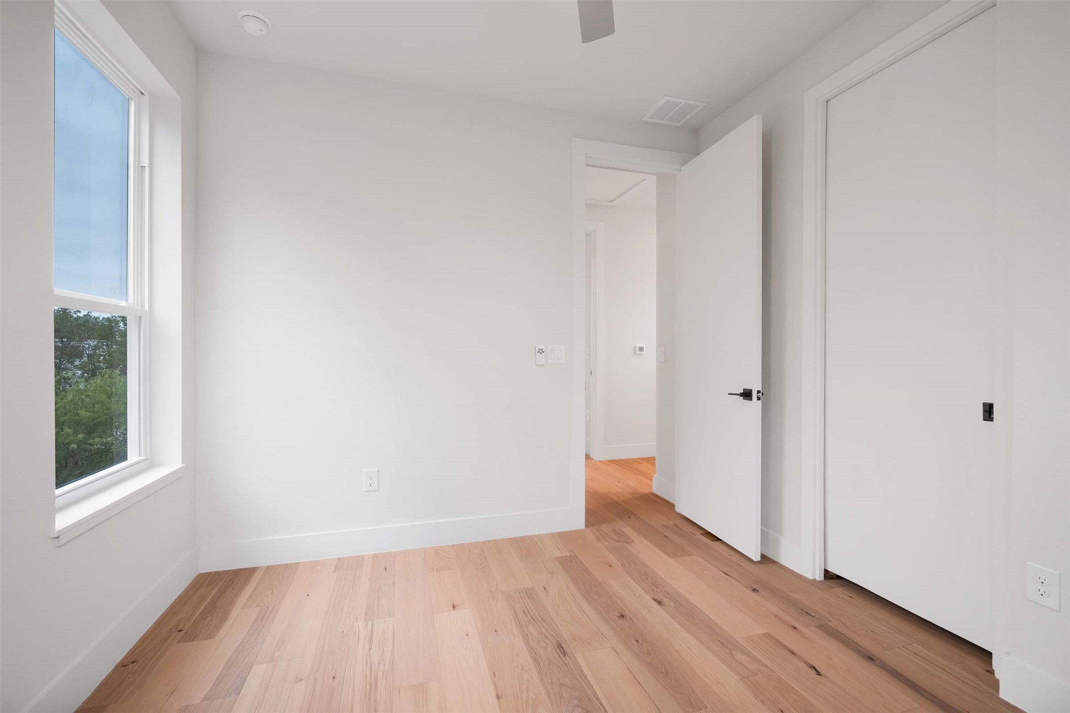 4513 South 3rd Street, Unit 2 Austin, TX 78745 - Photo 24 of 29 a view of an empty room with wooden floor and a window