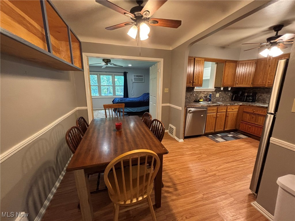 4742 Anderson Road Cleveland, OH 44124 - Photo 7 of 36 Dining area featuring light wood-type flooring and a ceiling fan.