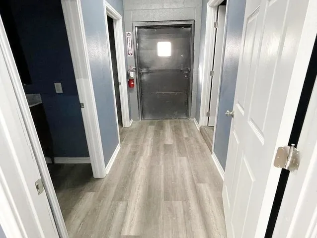 a view of a hallway with wooden floor