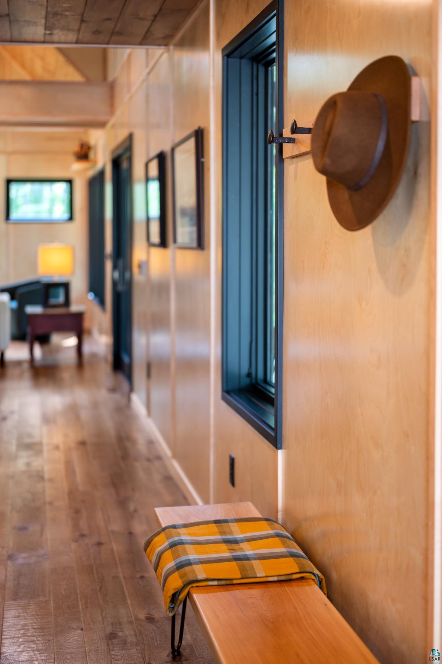 3778 East County Road Barnum, MN 55707 - Photo 17 of 52 Wood-finish flooring, light wood paneling, and a dark-framed window