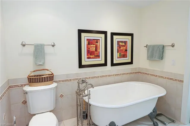 a white bath tub sitting next to a white toilet