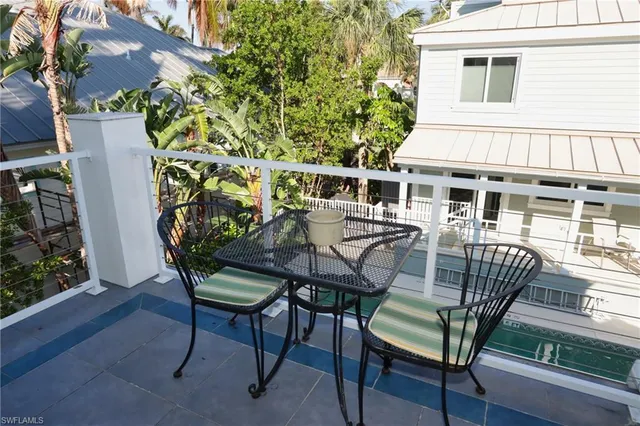 a view of a patio with table and chairs with wooden floor and plants