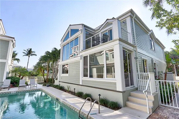 a house with swimming pool in front of it