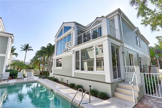 a house with swimming pool in front of it