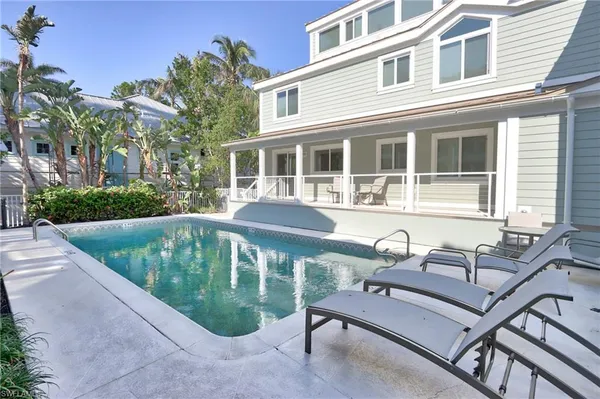 a view of a house with backyard sitting area and sitting area