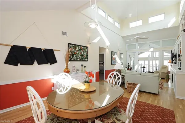 a dining room with furniture and wooden floor