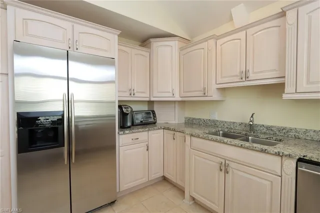 a kitchen with appliances cabinets and a sink