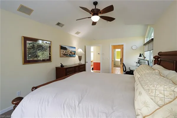 a bedroom with a large bed and a chandelier