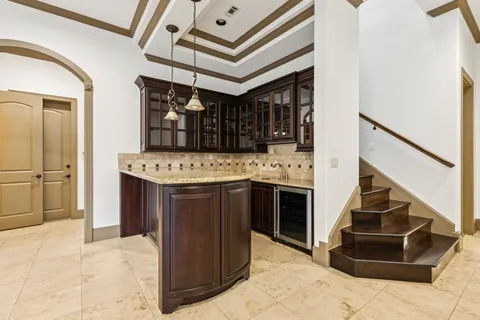 a kitchen with stainless steel appliances granite countertop a sink and dishwasher a stove with wooden cabinets