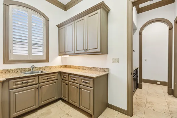 a kitchen with stainless steel appliances granite countertop a sink and dishwasher a stove with wooden cabinets