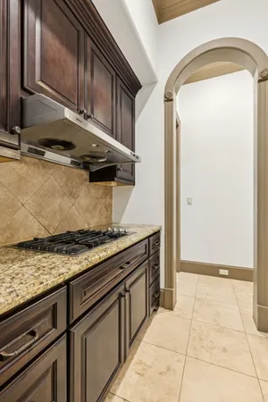 a kitchen with granite countertop a sink and a stove
