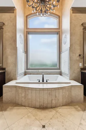 a bathroom with a bathtub and a mirror