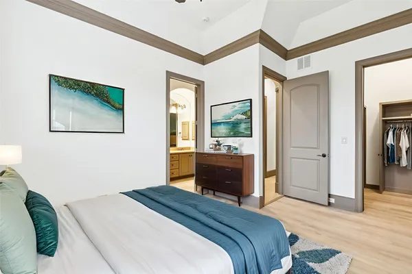 a bedroom with a bed and a dresser