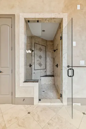 a bathroom with a tub shower and mirror