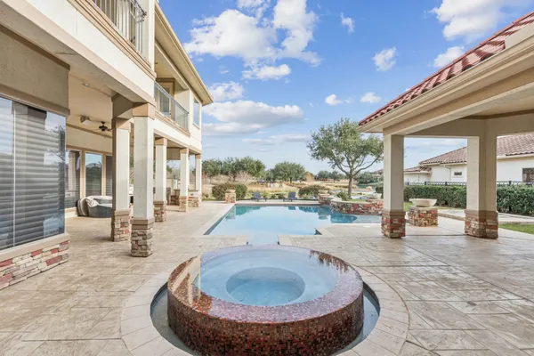 a swimming pool with outdoor seating