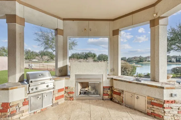 a living room with furniture a fireplace and a large window