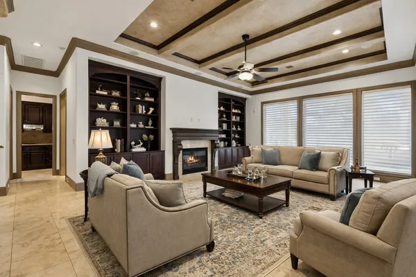 a living room with fireplace furniture and a large window