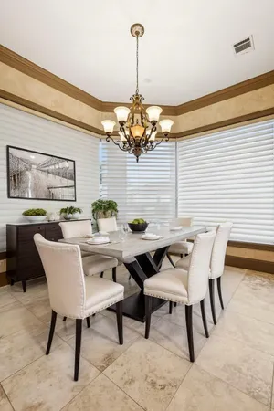 a view of a dining room with furniture and chandelier