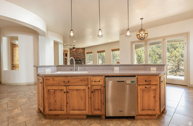 888 East Fiddlers Canyon Road Cedar City, UT 84721 - Photo 18 of 74 Kitchen featuring stainless steel dishwasher, light stone countertops, and decorative light fixtures