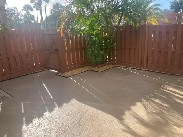 a view of backyard with wooden fence