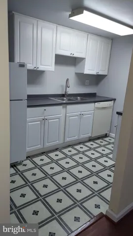 a kitchen with kitchen island a stove a sink and a refrigerator