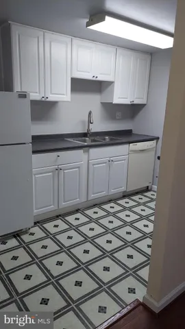 a kitchen with cabinets and appliances