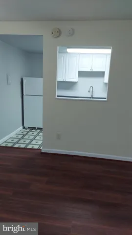 a view of a kitchen with wooden floor