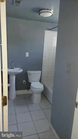 a white toilet sitting next to a bathroom sink