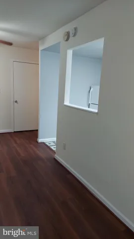 an empty room with wooden floor and closet