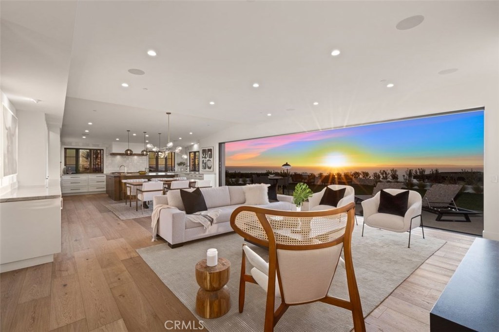 a living room with a couch and dining table with wooden floor