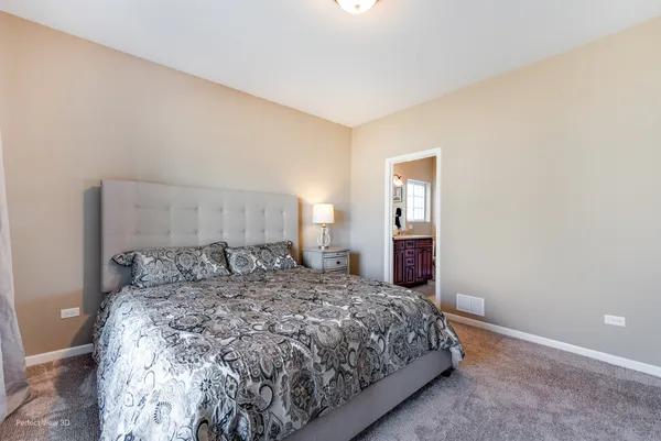 a bed sitting in a bedroom and table