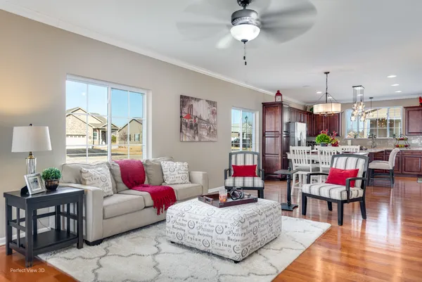 a living room with furniture and kitchen view