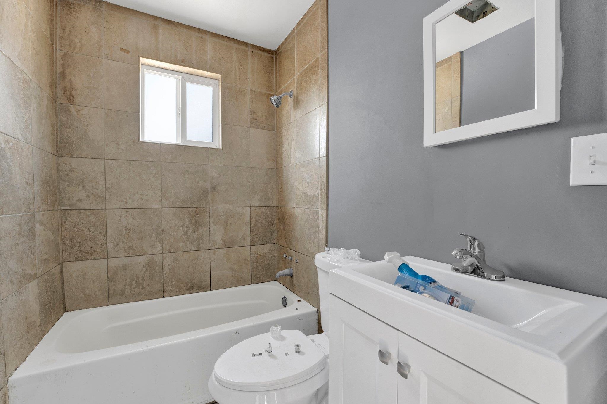 2161 Charjean Road Memphis, TN 38114 - Photo 12 of 18 Full bathroom with vanity, tiled shower / bath combo, and toilet