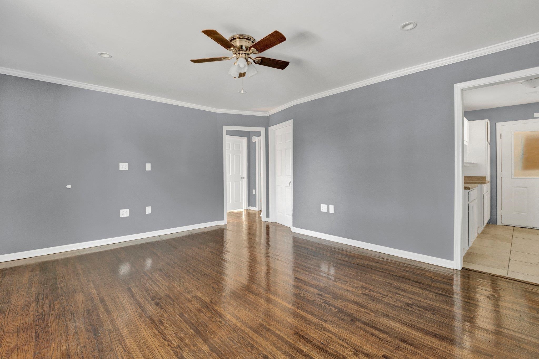 2161 Charjean Road Memphis, TN 38114 - Photo 3 of 18 Spare room featuring ceiling fan, dark hardwood / wood-style flooring, and ornamental molding