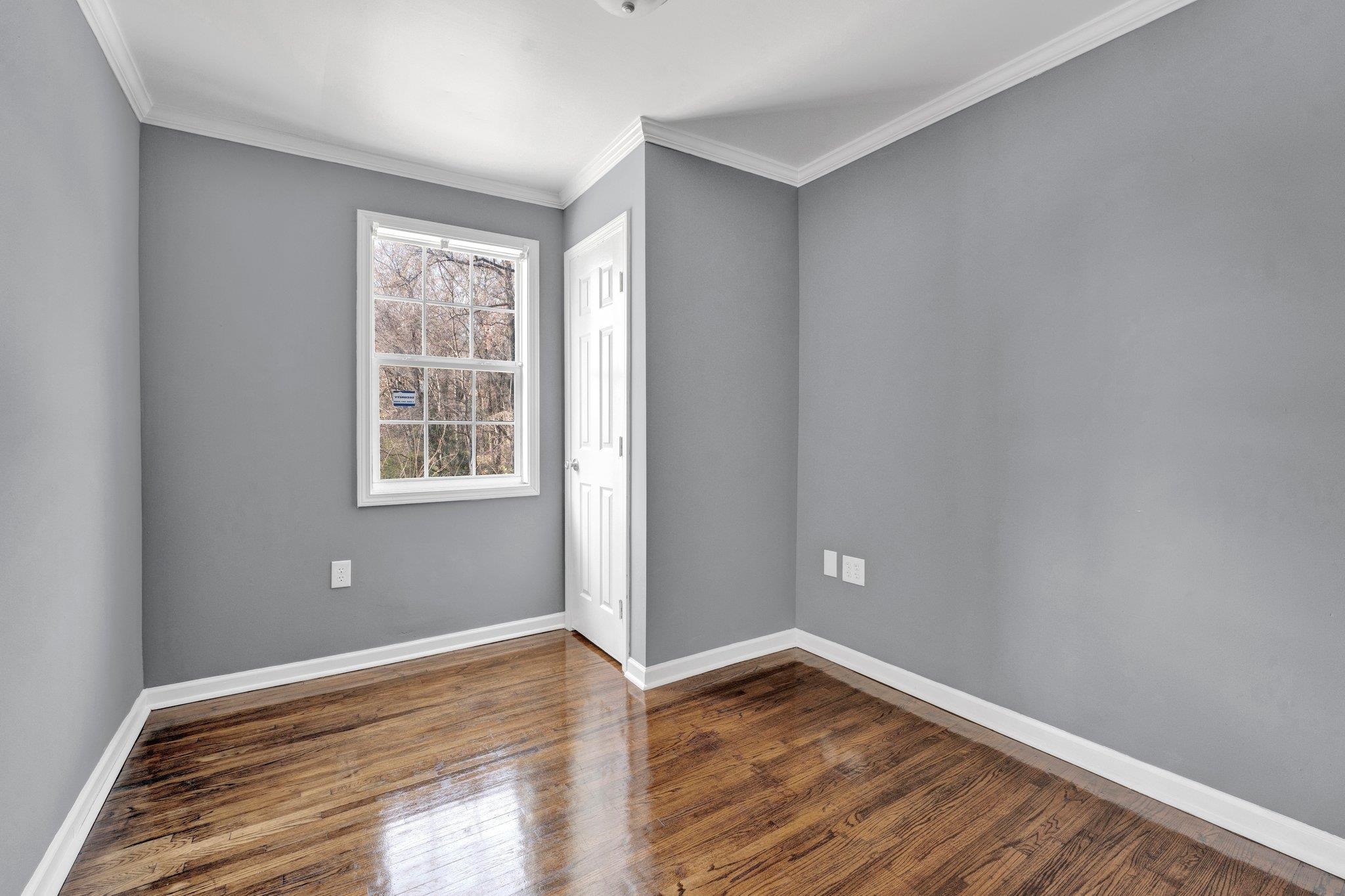 2161 Charjean Road Memphis, TN 38114 - Photo 10 of 18 Empty room featuring dark hardwood / wood-style flooring and ornamental molding