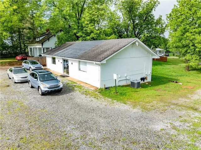 a car parked in front of a house with a yard