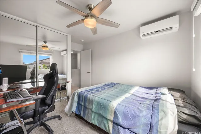 a bedroom with a bed a desk and chair