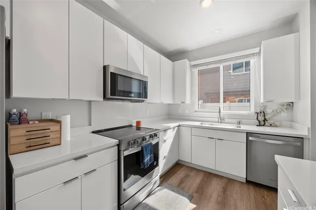 a kitchen with a sink stove and microwave
