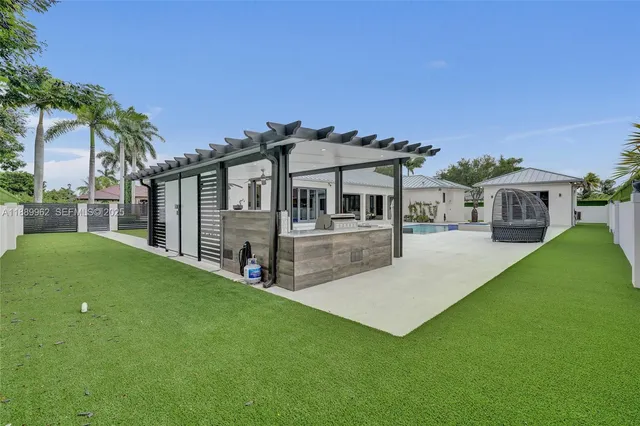 a view of an house with swimming pool and sitting area