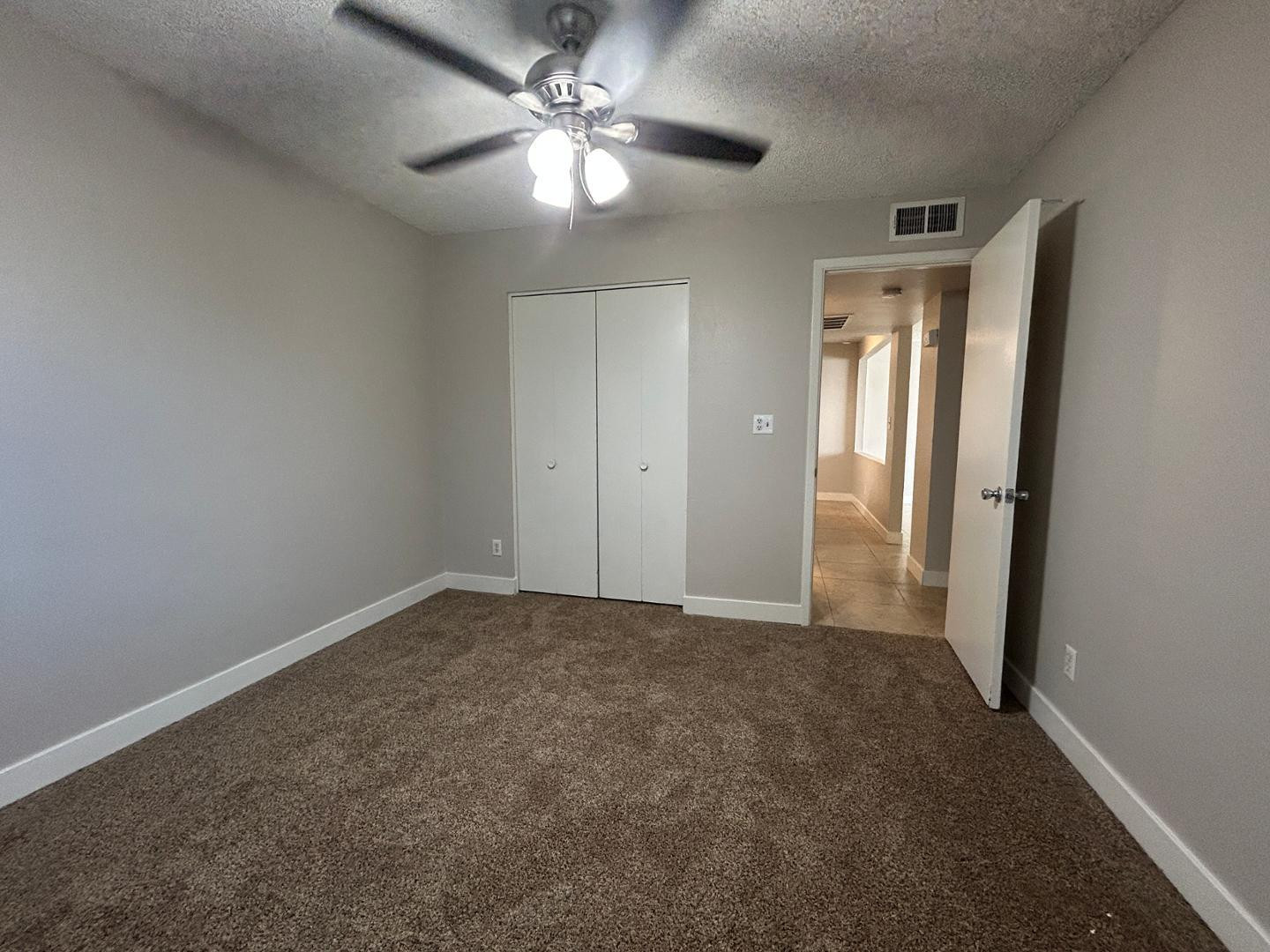 859 South Ext Road Mesa, AZ 85210 - Photo 14 of 19 an empty room with closet and a ceiling fan