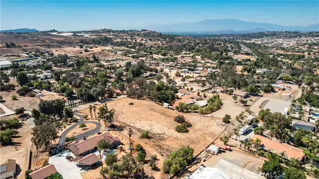 an aerial view of residential houses with yard
