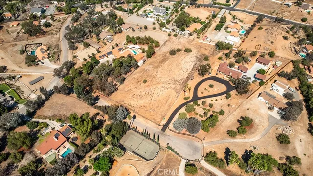 an aerial view of a house with a mountain