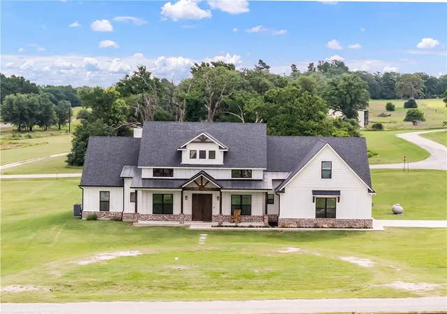 a front view of house with yard swimming pool and outdoor seating