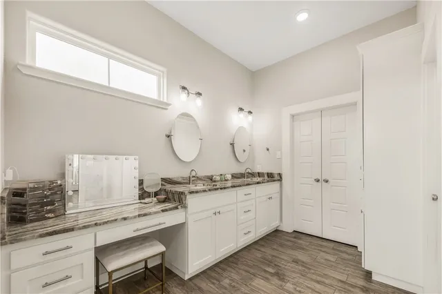 a room with a sink cabinets and wooden floor