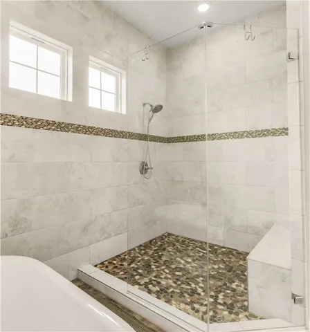 a bathroom with a bath tub and shower