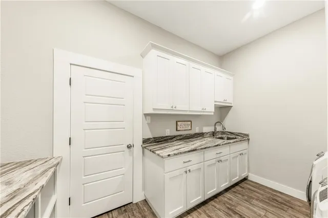 a kitchen with granite countertop white cabinets and white appliances