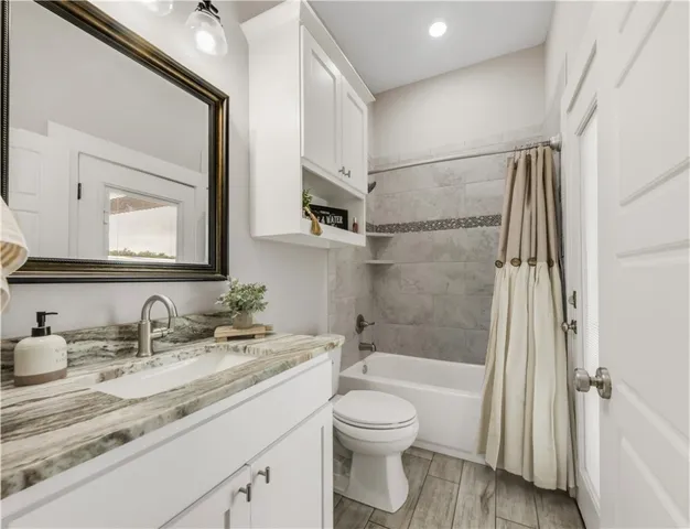 a living room with patio furniture and a floor to ceiling window